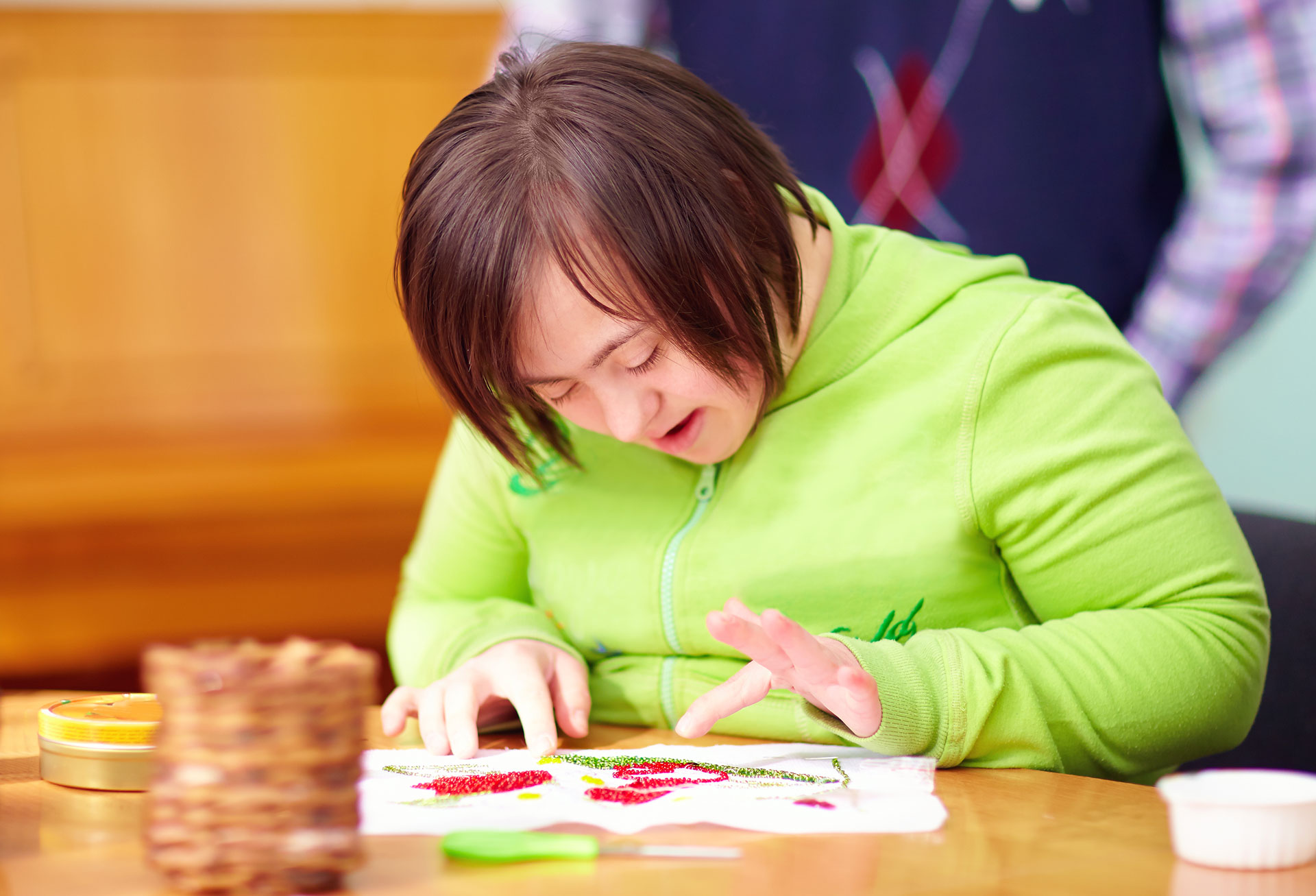 young female adult with special needs working on art project